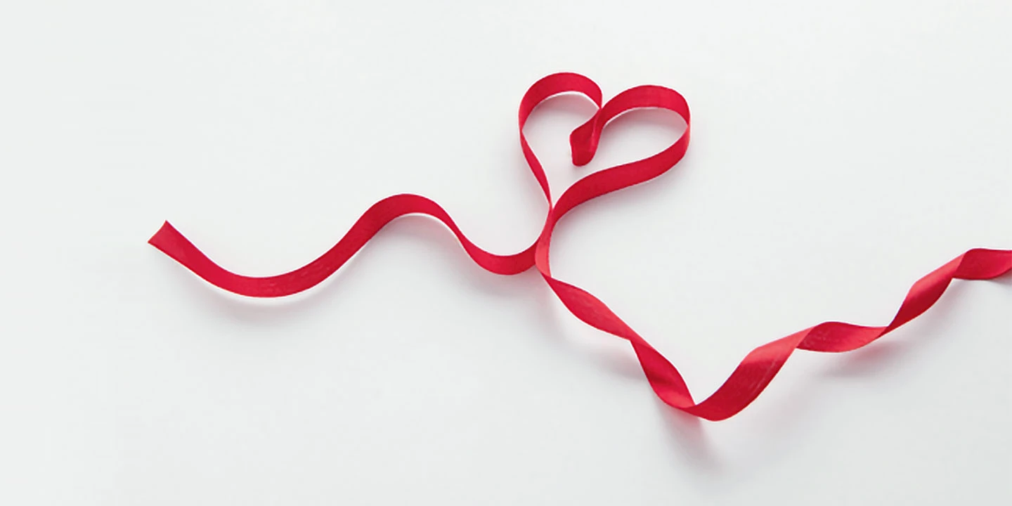 A heart shaped from red ribbon